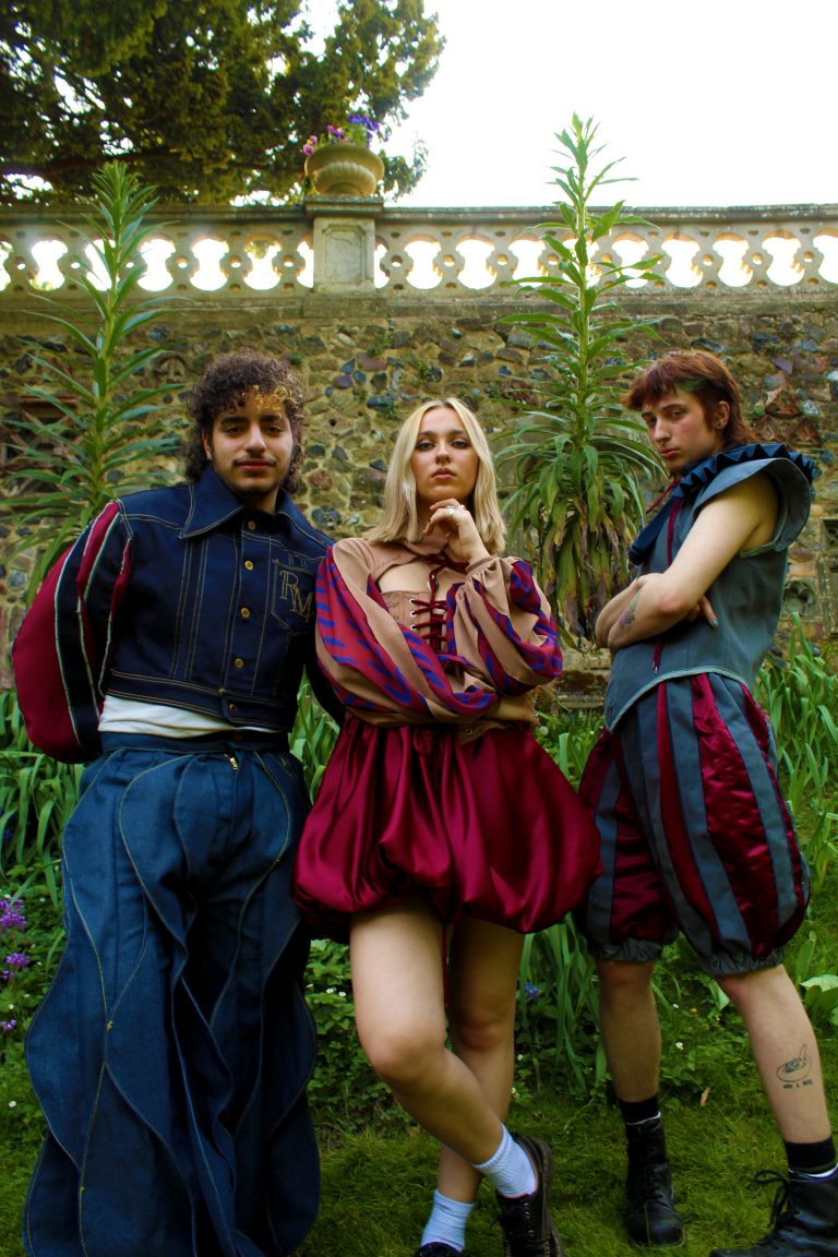 Fashion work by Mia Bartram showing a blue denim outfit, a red dress and jumper and a grey vest with puffy grey shorts.