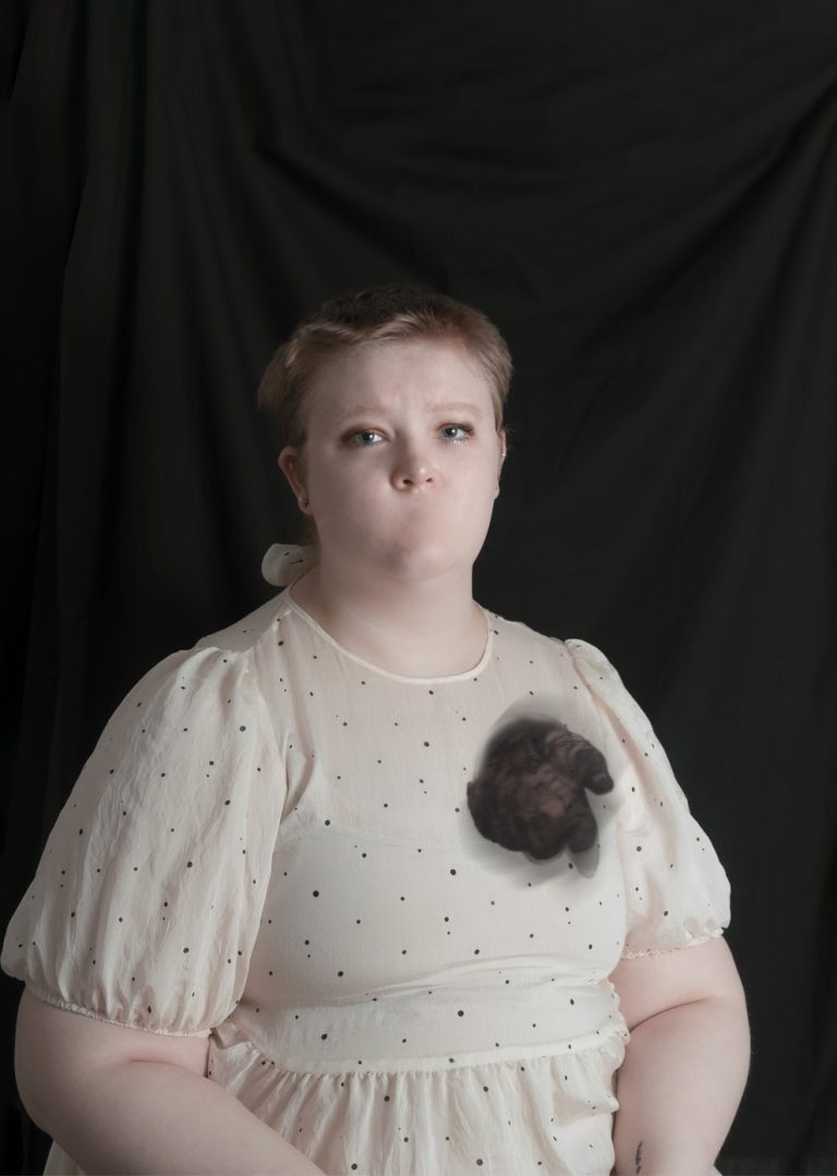 A fine art self-portrait by Samantha Drage depicting the artist with no mouth and a ghostly hand reaching from the chest.