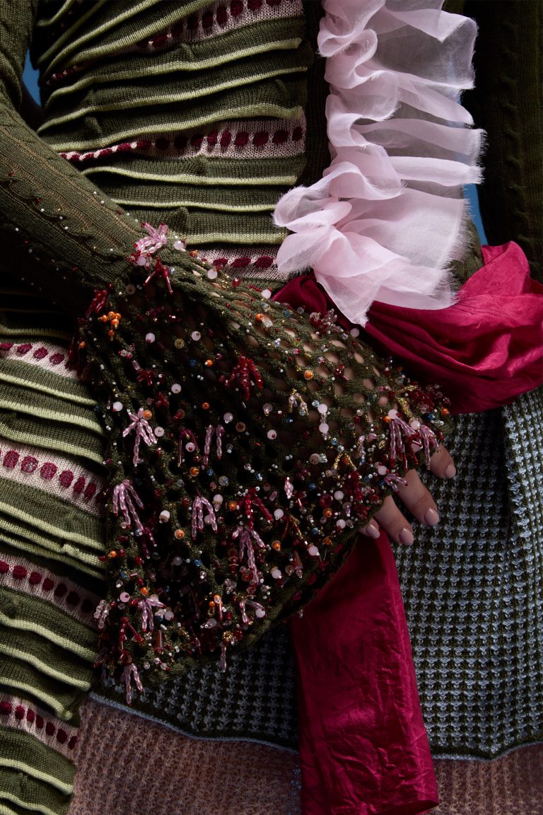 Knitted garment with dyed silk detailing and a focus on a heavily embellished mesh-knitted sleeve by Millie Anderson