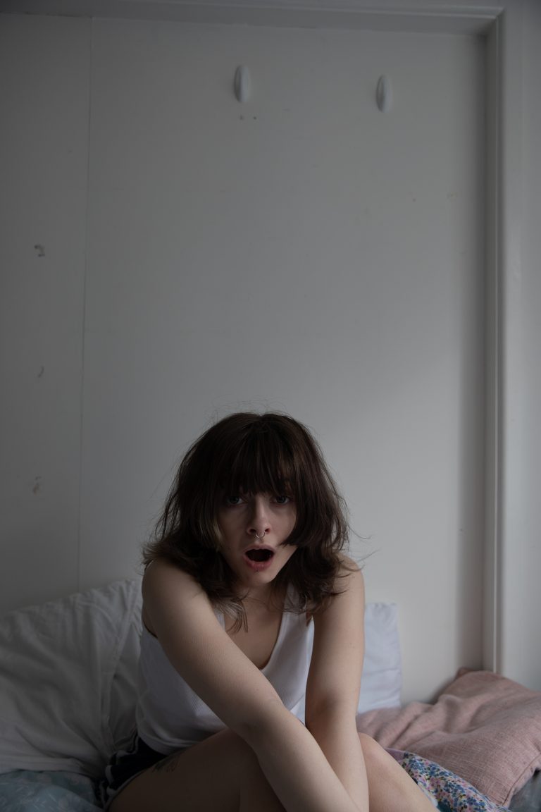 Still image, photography by Monika Świat showing a young female yawning.