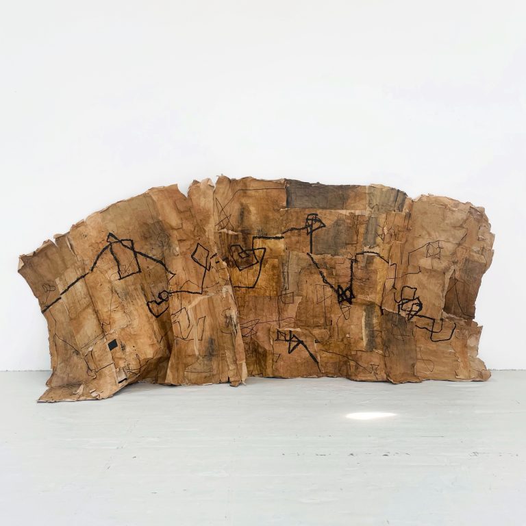 Fine art works by Jodie Emms showing recycled brown paper: a development piece with a bold oil line.