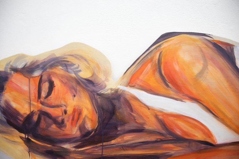 A close-up photograph of BA Fine Art student Darcy Hamond’s large wooden lady, painted as if she’s asleep.