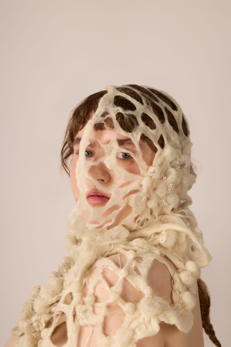 Textile work by Nella Upton showing a model with white lace like samples