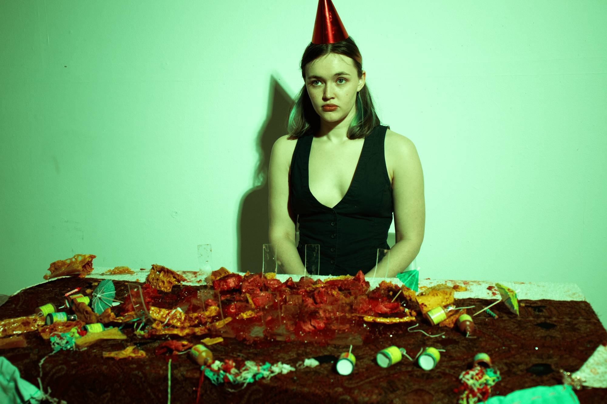 Fine Art work by Amy White documenting an eating performance imitating an uncanny birthday party. The sculpture depicts a honeycomb ribcage and jelly intestines, consumed by the artist.