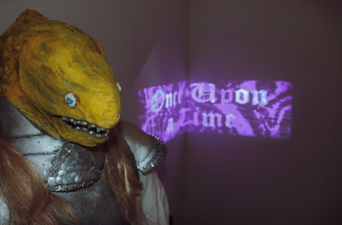 Projected film installation about an eel knight and princess with mixed media sculpture using sand, Corriedale wool, EVA foam, sequins, marigolds and fabric